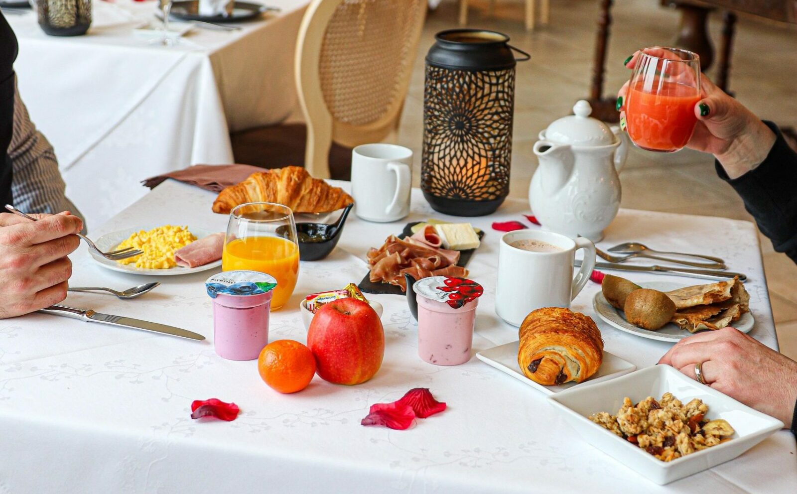 Gourmet buffet breakfast at Le Fleuray featuring fresh pastries, breads, fruits, and local products